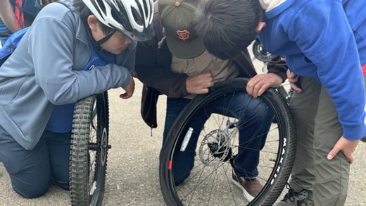 scouts learning to fix tires at bike rodeo