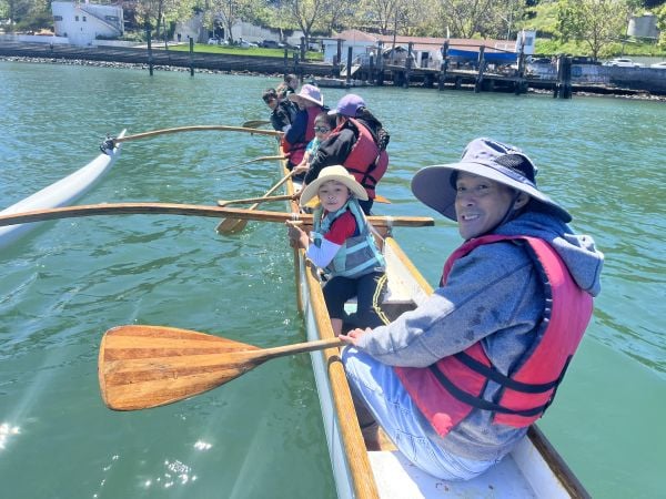 Adults and scouts in an outrigger canoe at Aquatic Park, SF