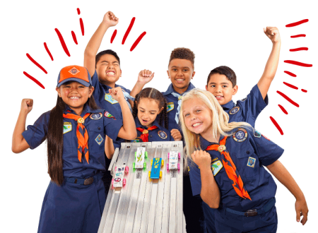 Cheering cub scouts around a pinewood derby track